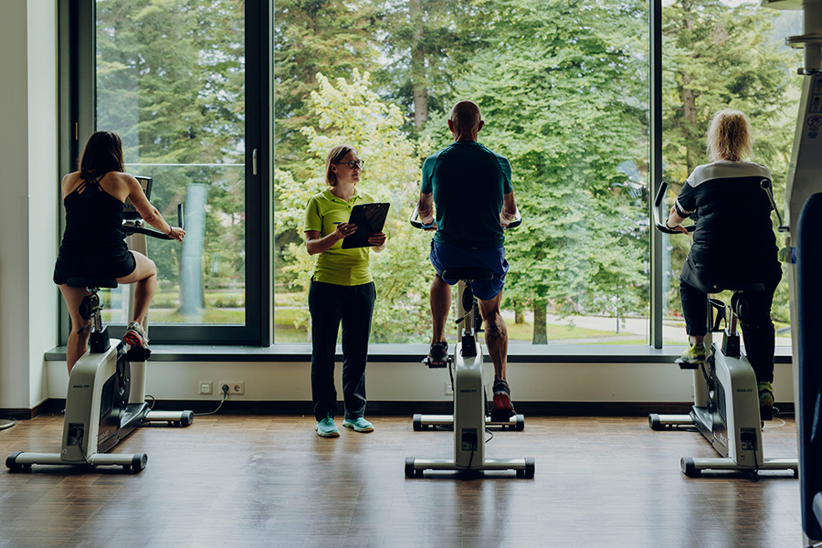 Rehabilitanden trainieren auf dem Ergometer Rehabilitanden trainieren auf dem Ergometer